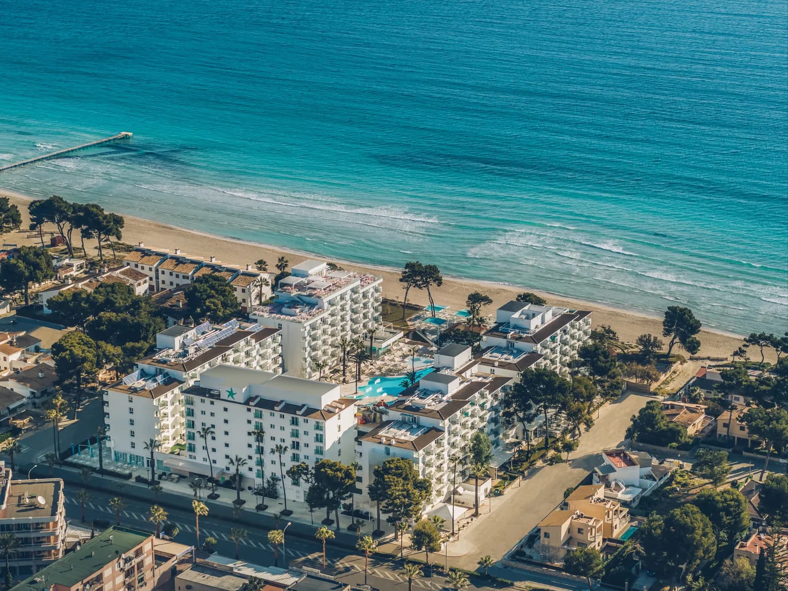 Iberostar Waves Alcudia Park buildings and pools beside Playa de Muro beach
